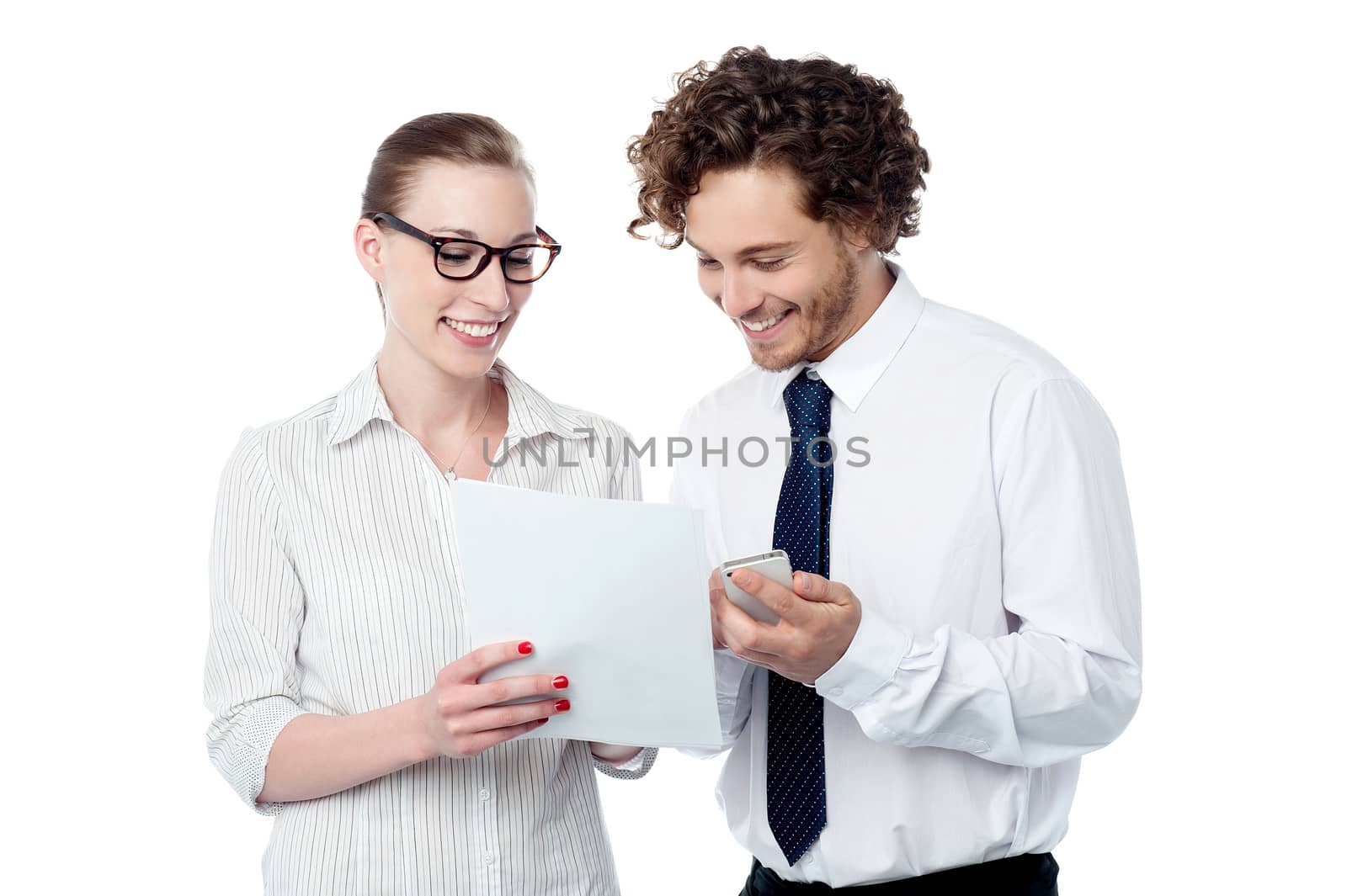 Colleagues reviewing business document by stockyimages