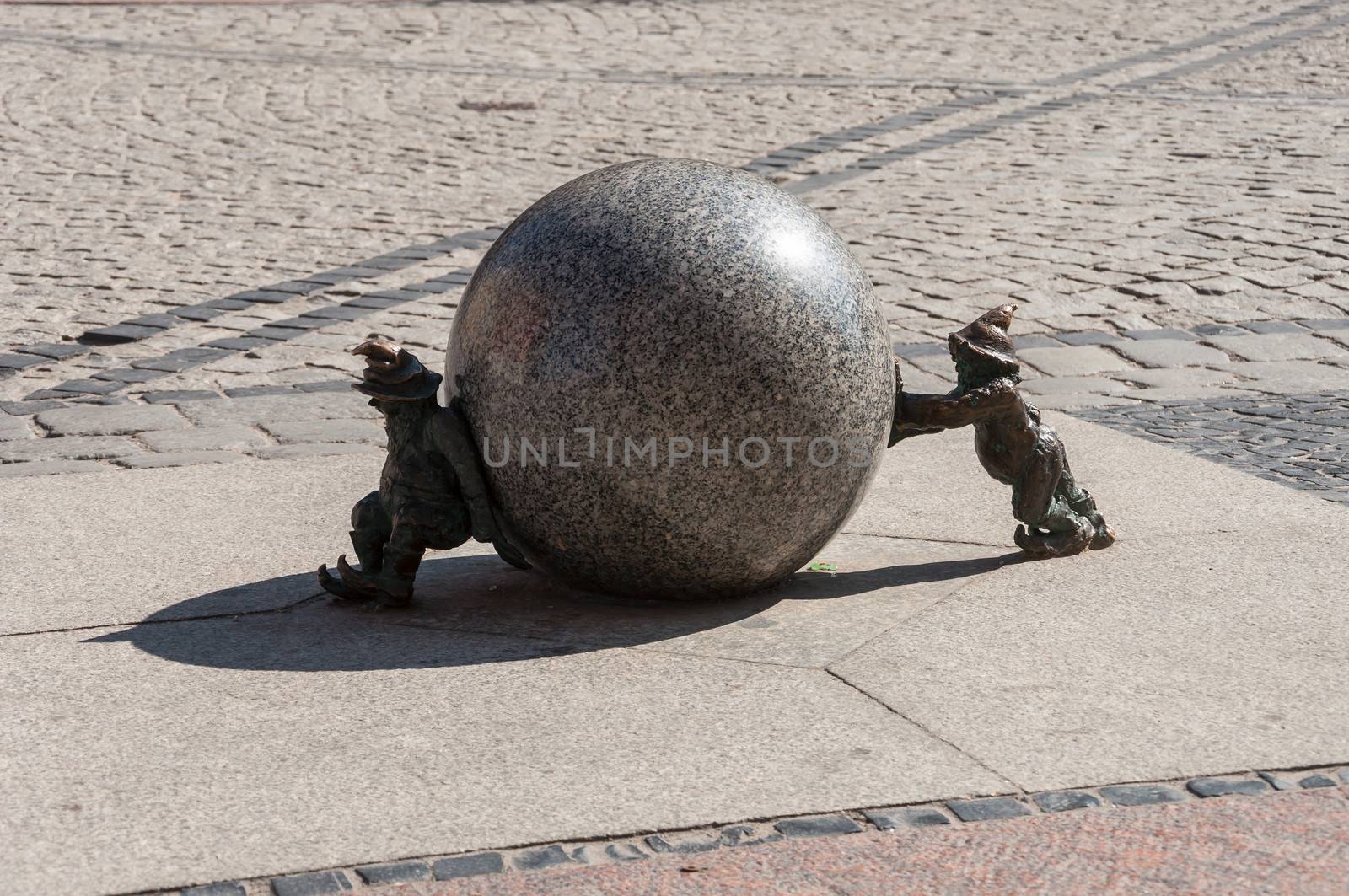 Stone dwarfs with ball on the street.