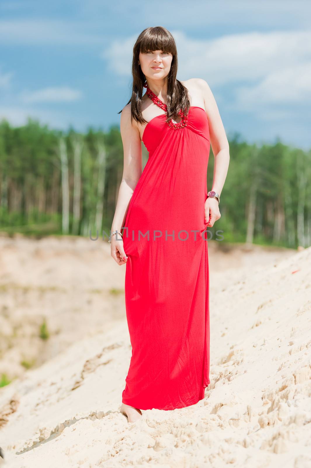 A girl in a red dress posing on a sand dune by kosmsos111