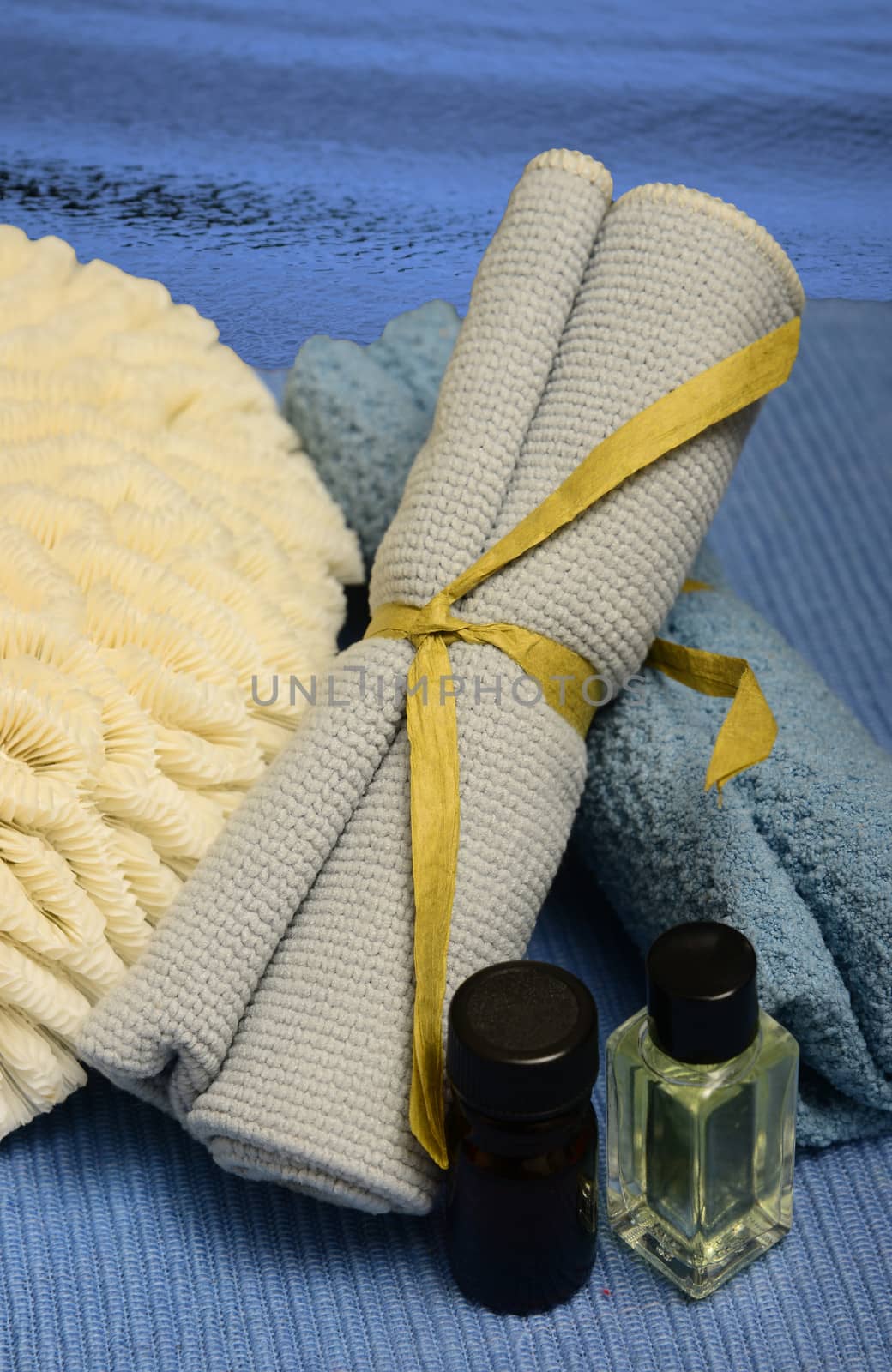 assortment of spa products on blue with essential oils for aromatherapy