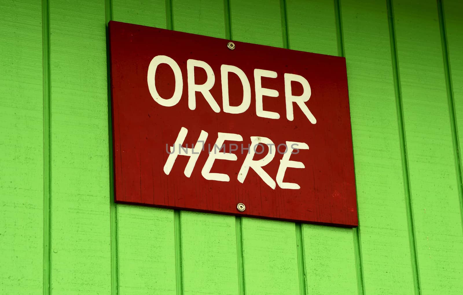 order here sign on green wall