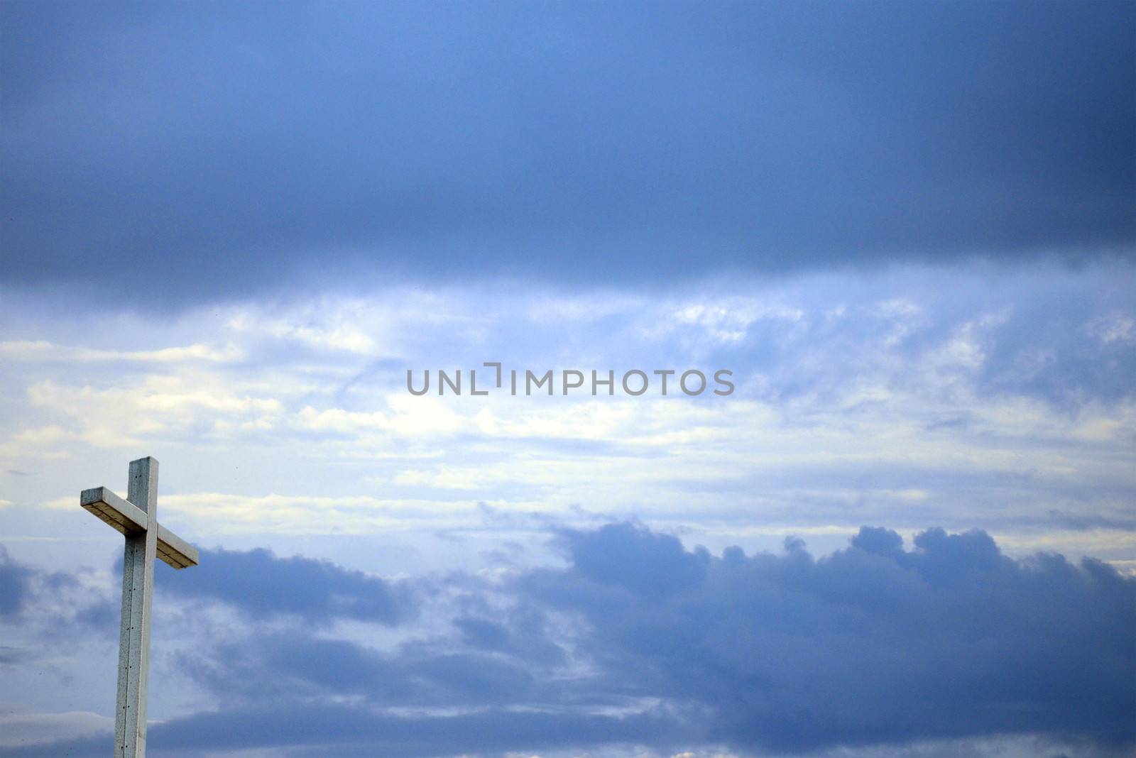 Christian background with cross sun shining through and sky