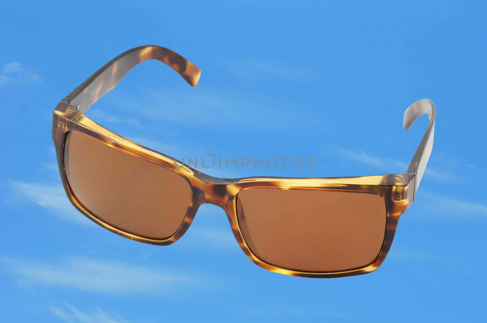 brown sunglasses for fashion on a bright blue sky
