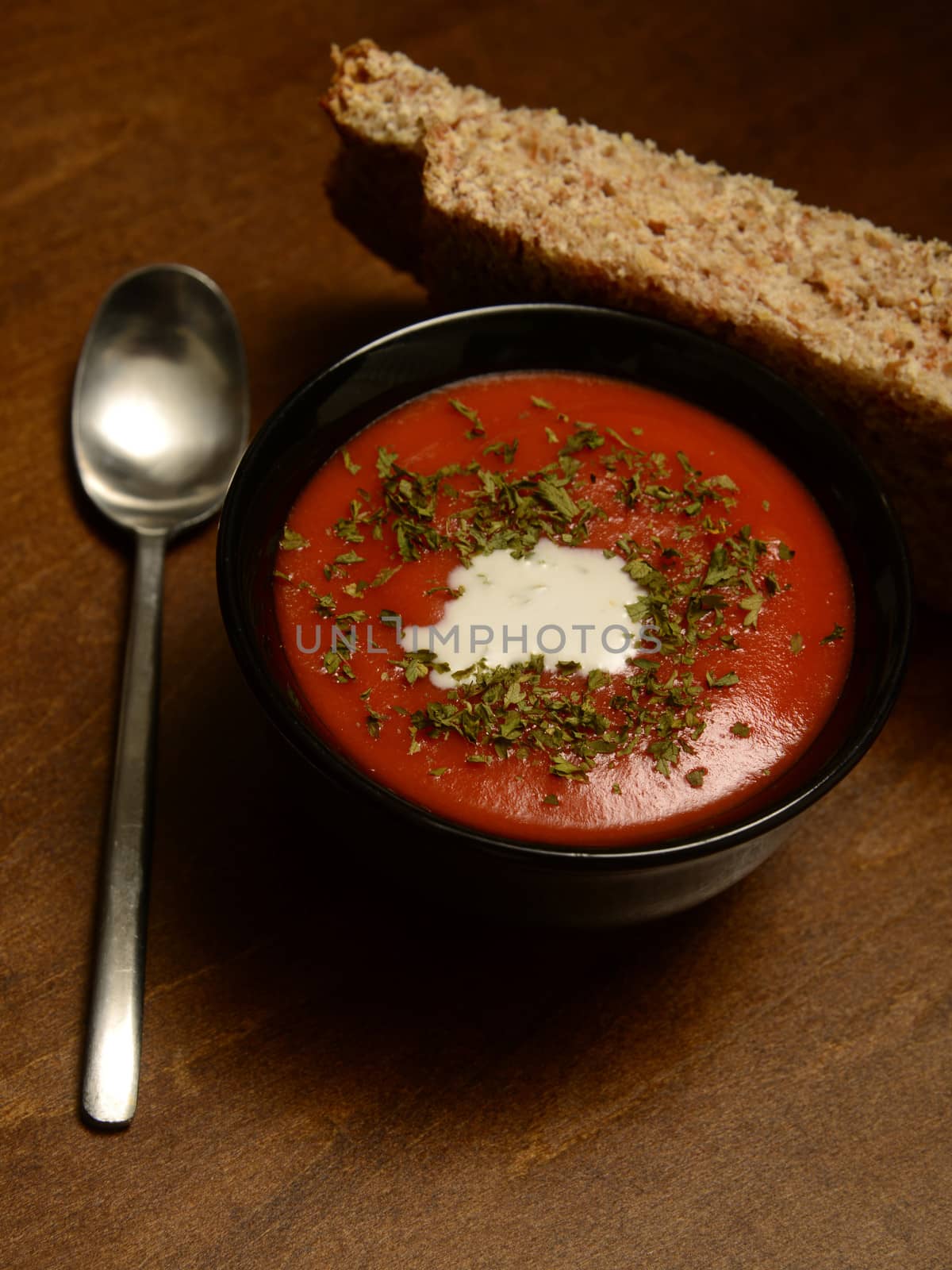 savory tomato soup and bread in rustic and cozy setting