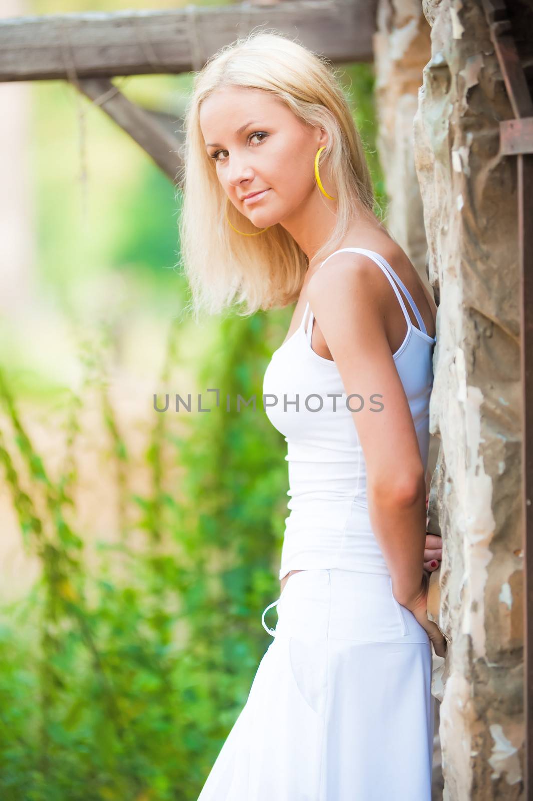 Young slim woman in white at the railing