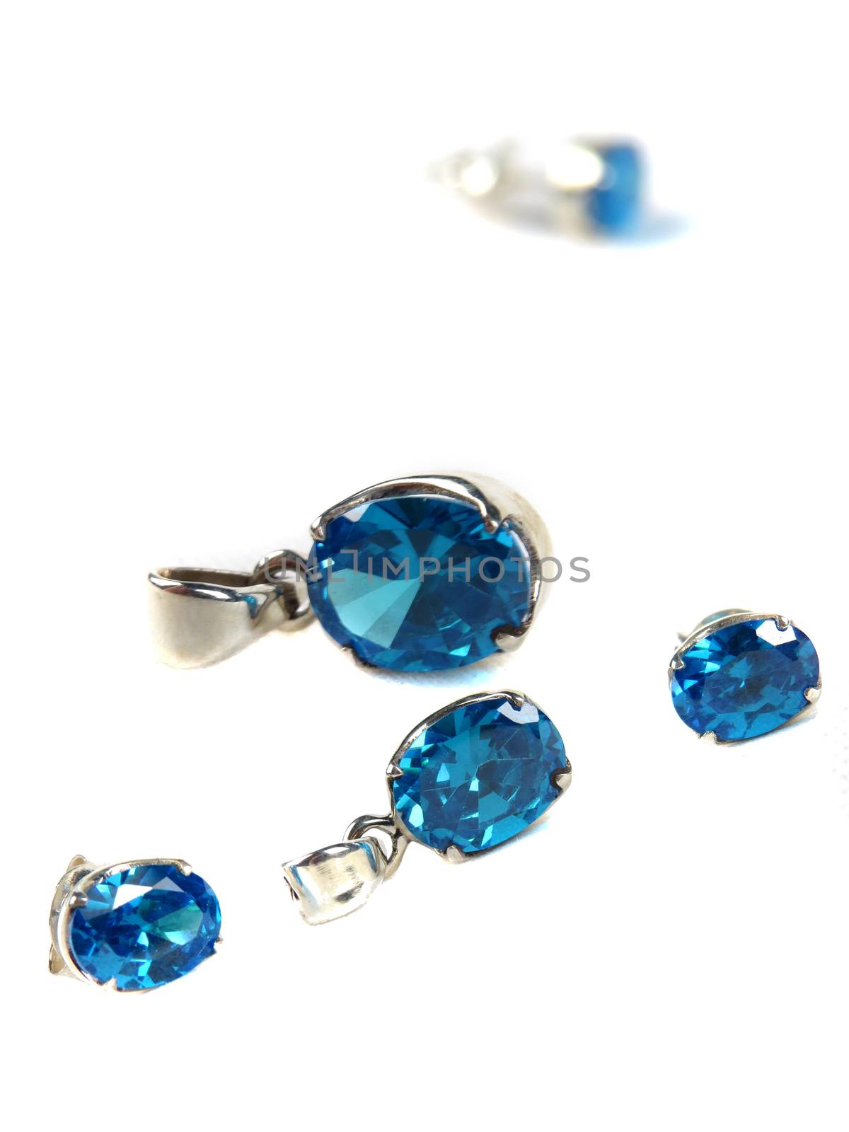 A set of silver jewelery with blue gemstones consisting of pendants and earrings                               