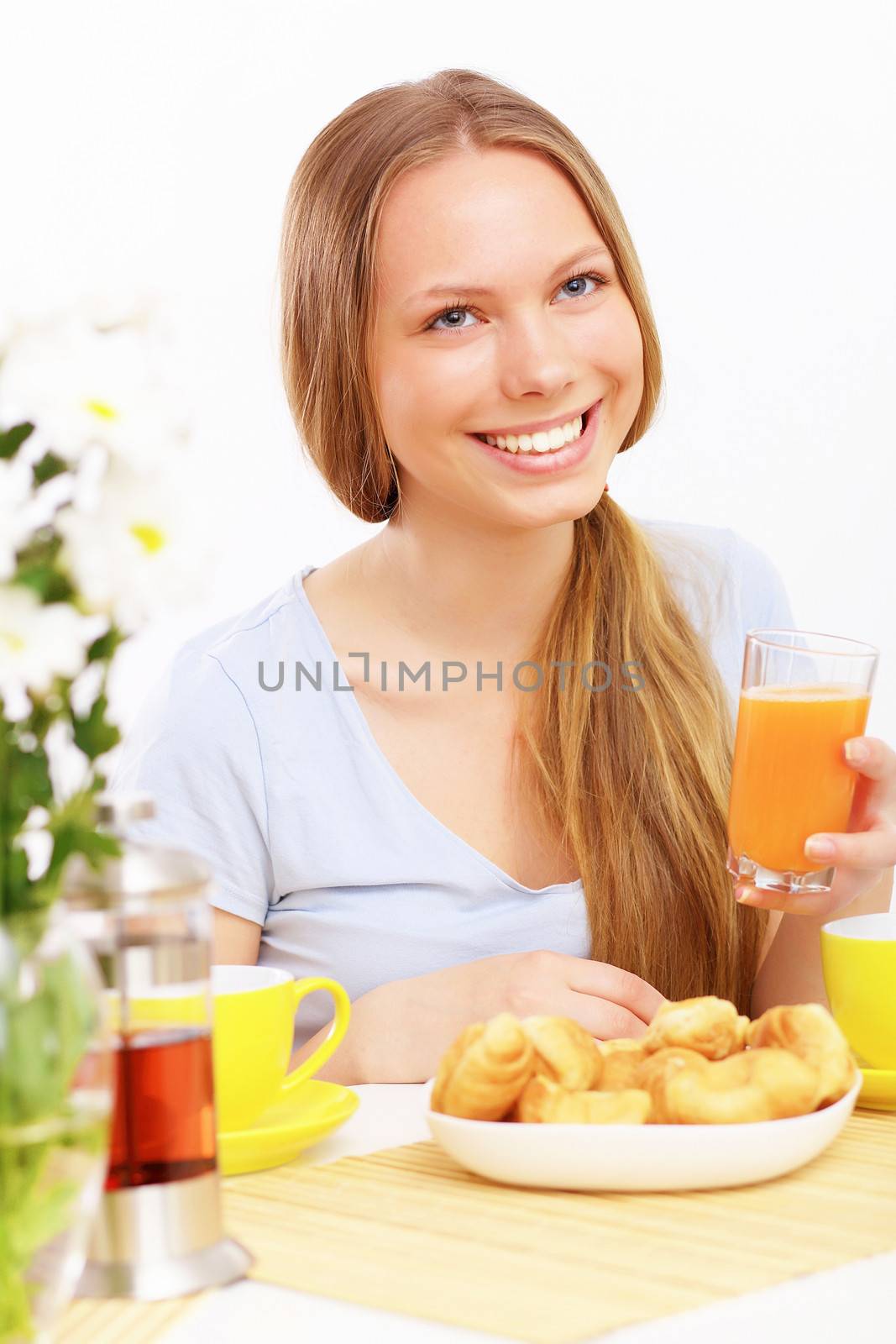 Beautiful young woman drinking tea from yellow cup