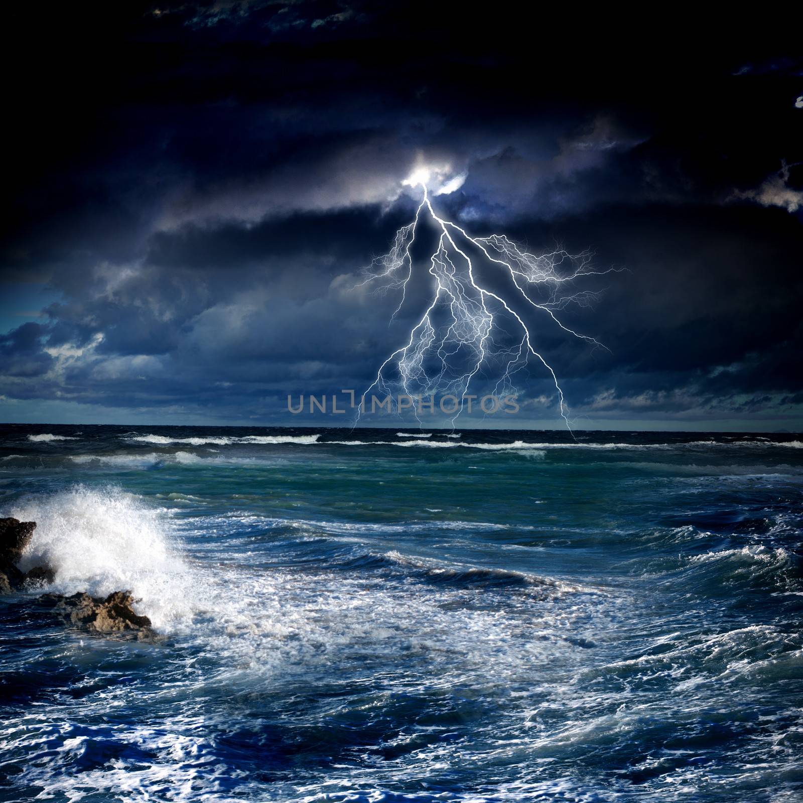 Image of night stormy sea with big waves and lightning