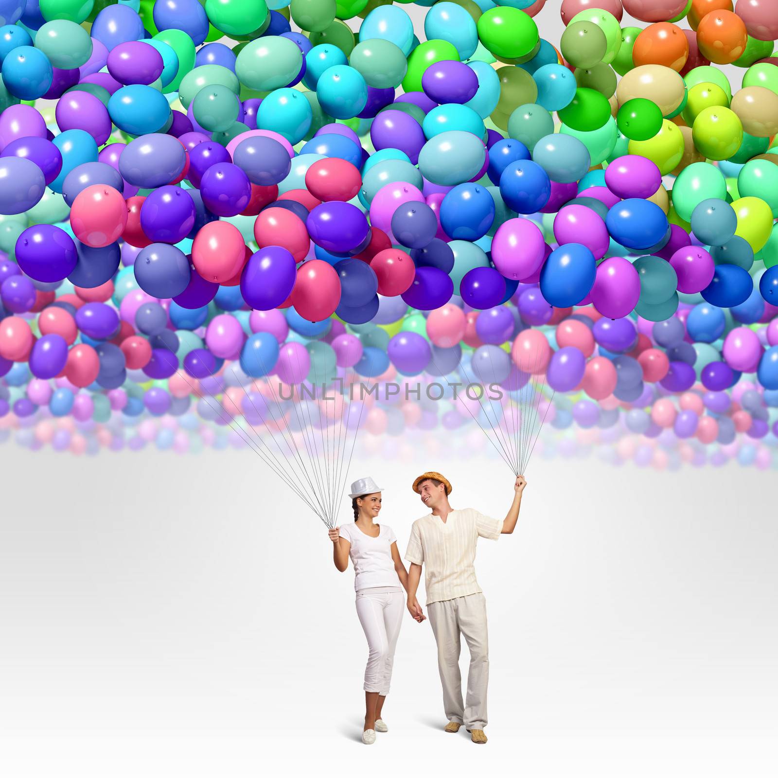 Image of young couple holding bunch of colorful balloons