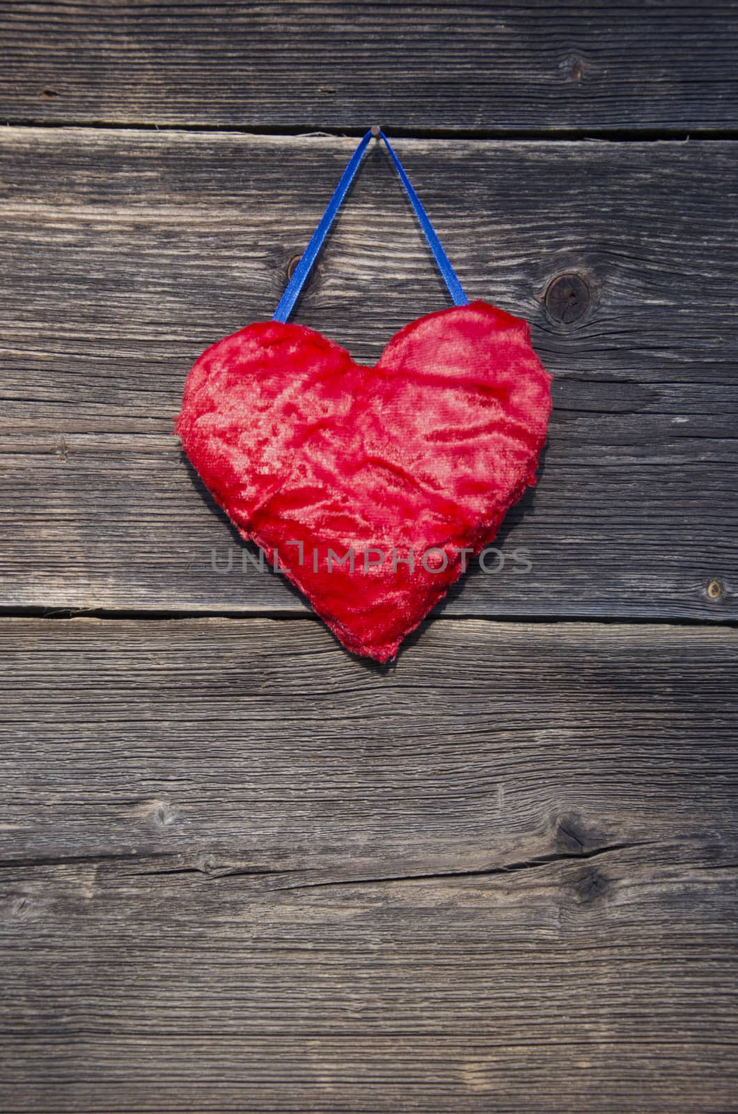 red heart symbol on old wooden farm barn wall