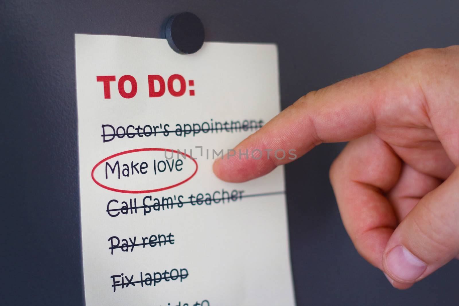 Conceptual image of making love a priority with a male finger pointing to a To Do List on which all things have been crossed out except Make Love which is ringed in red