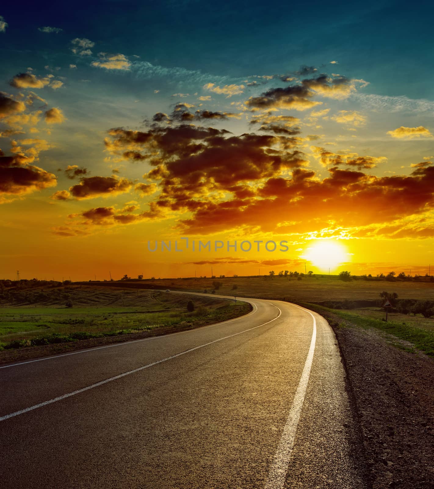 beautiful sunset over asphalt road by mycola