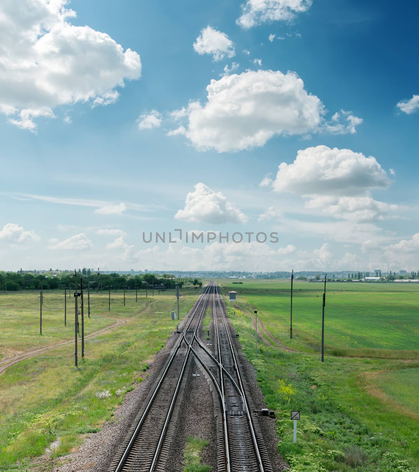 railroad to horizon and clouds on sky by mycola