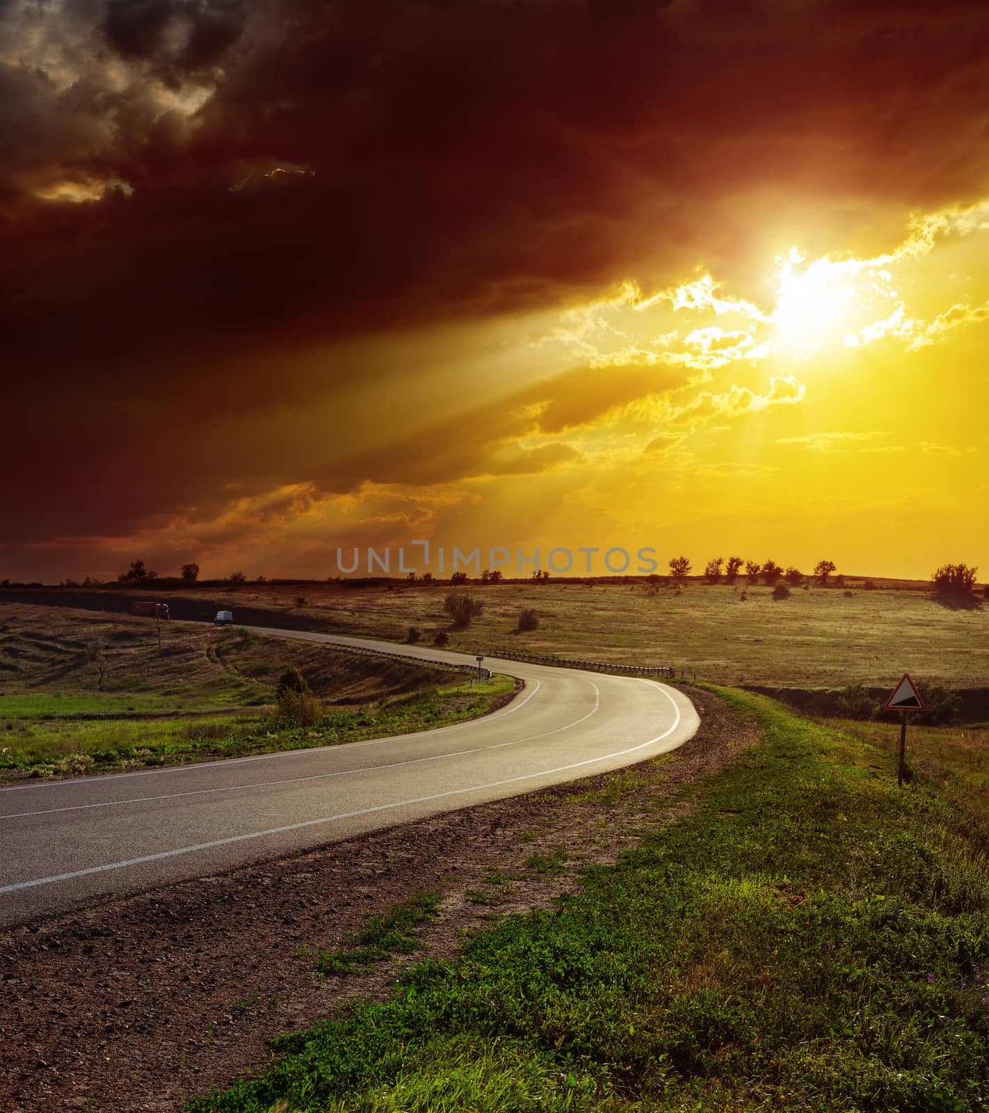 orange dramatic sunset over asphalt road by mycola