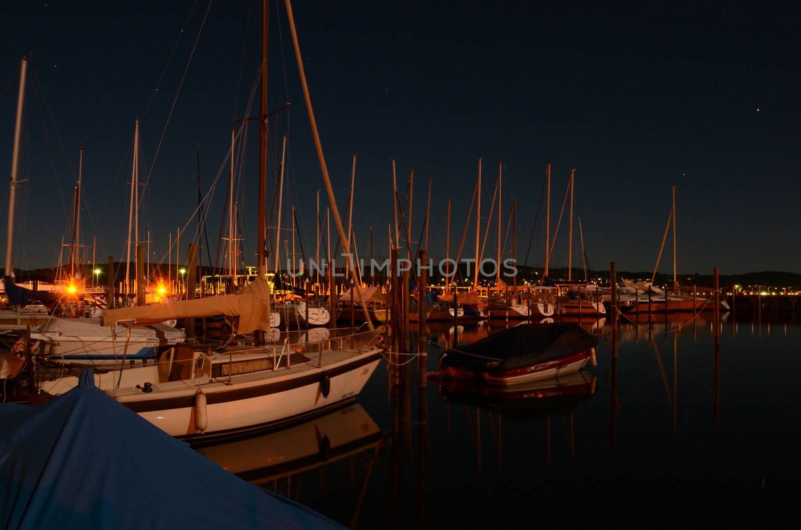 Sailing boats on a crisp, stary night at an italian marina