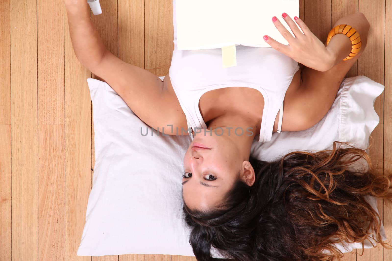 A young adult woman relaxing after reading a book.