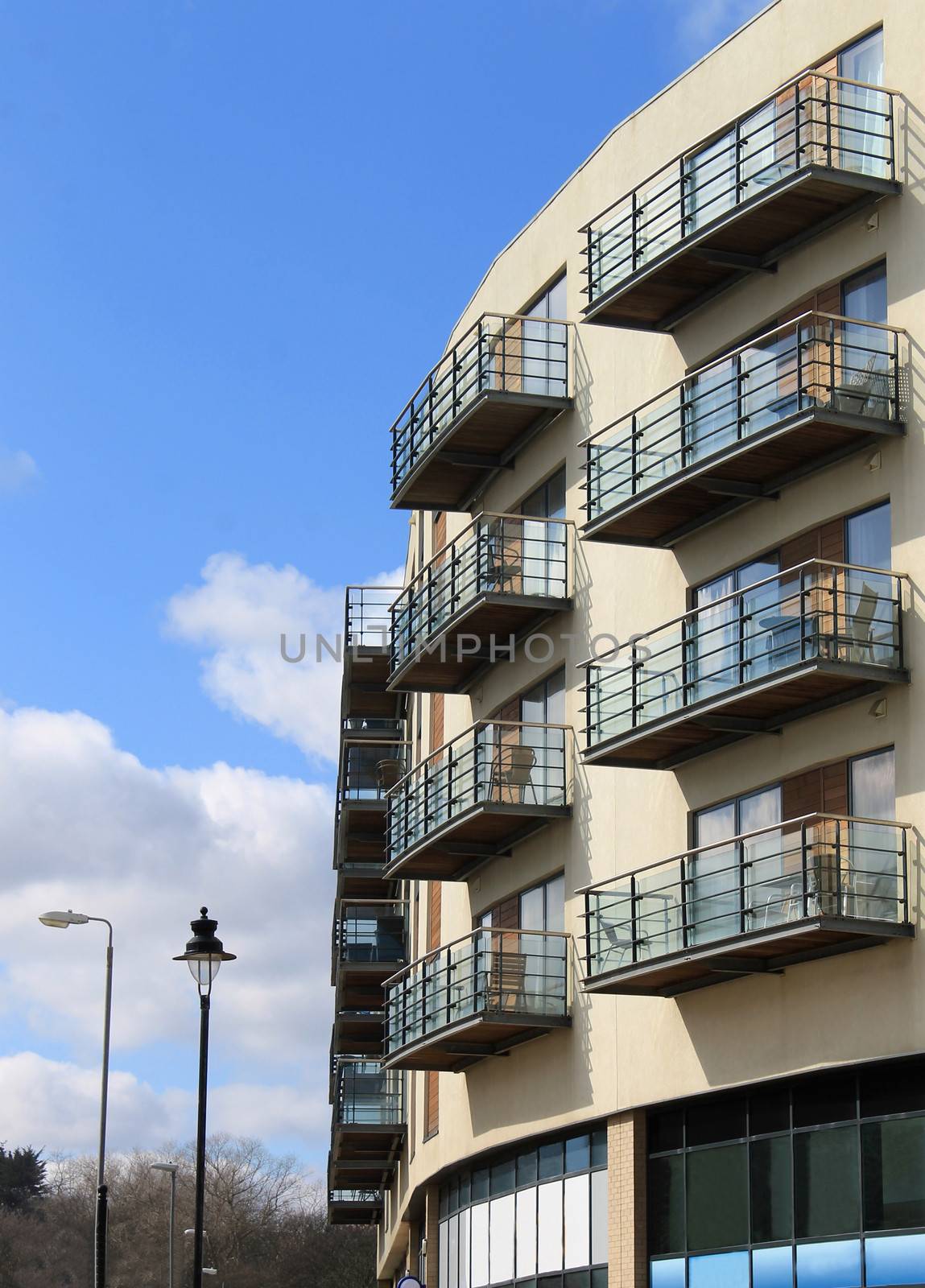Exterior of modern apartment building with cloudscape background.