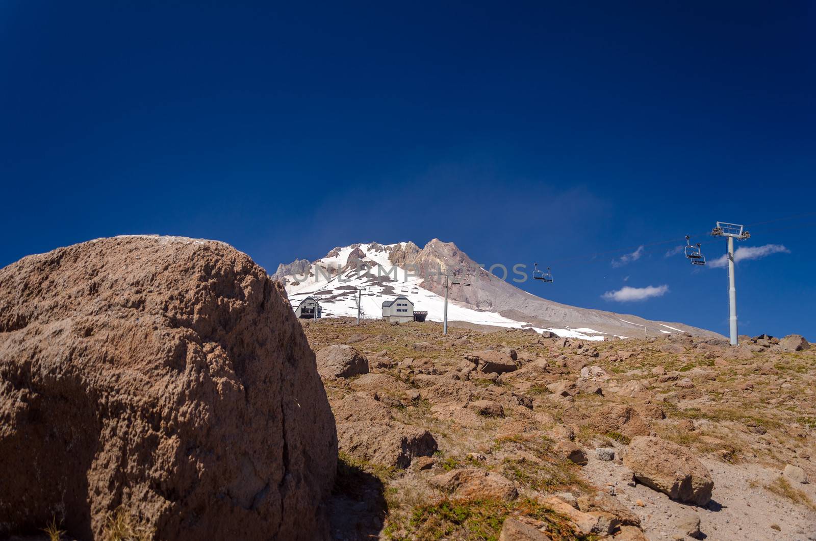 View of the summit of Mount Hood with a boulder in the foreground