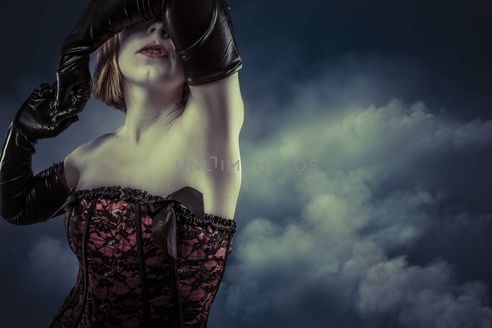 Portrait of a beautiful blonde woman with corset over cloudy background
