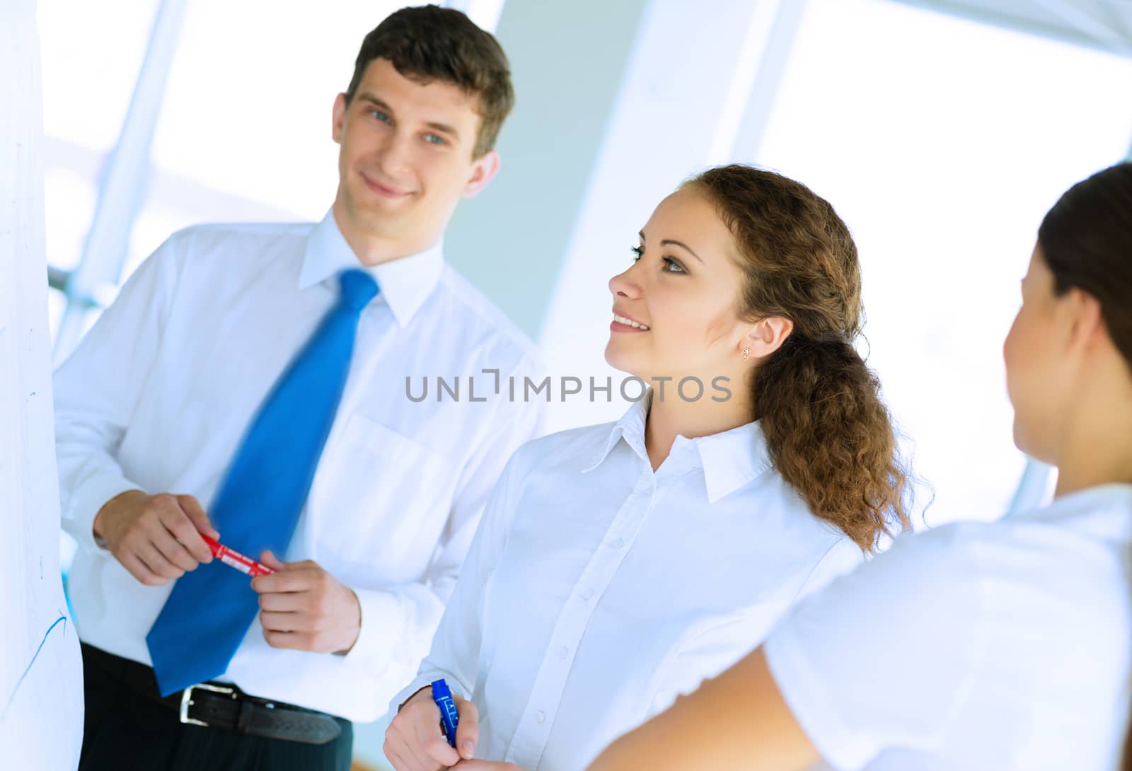 businessmen are meeting near the flipchart by adam121