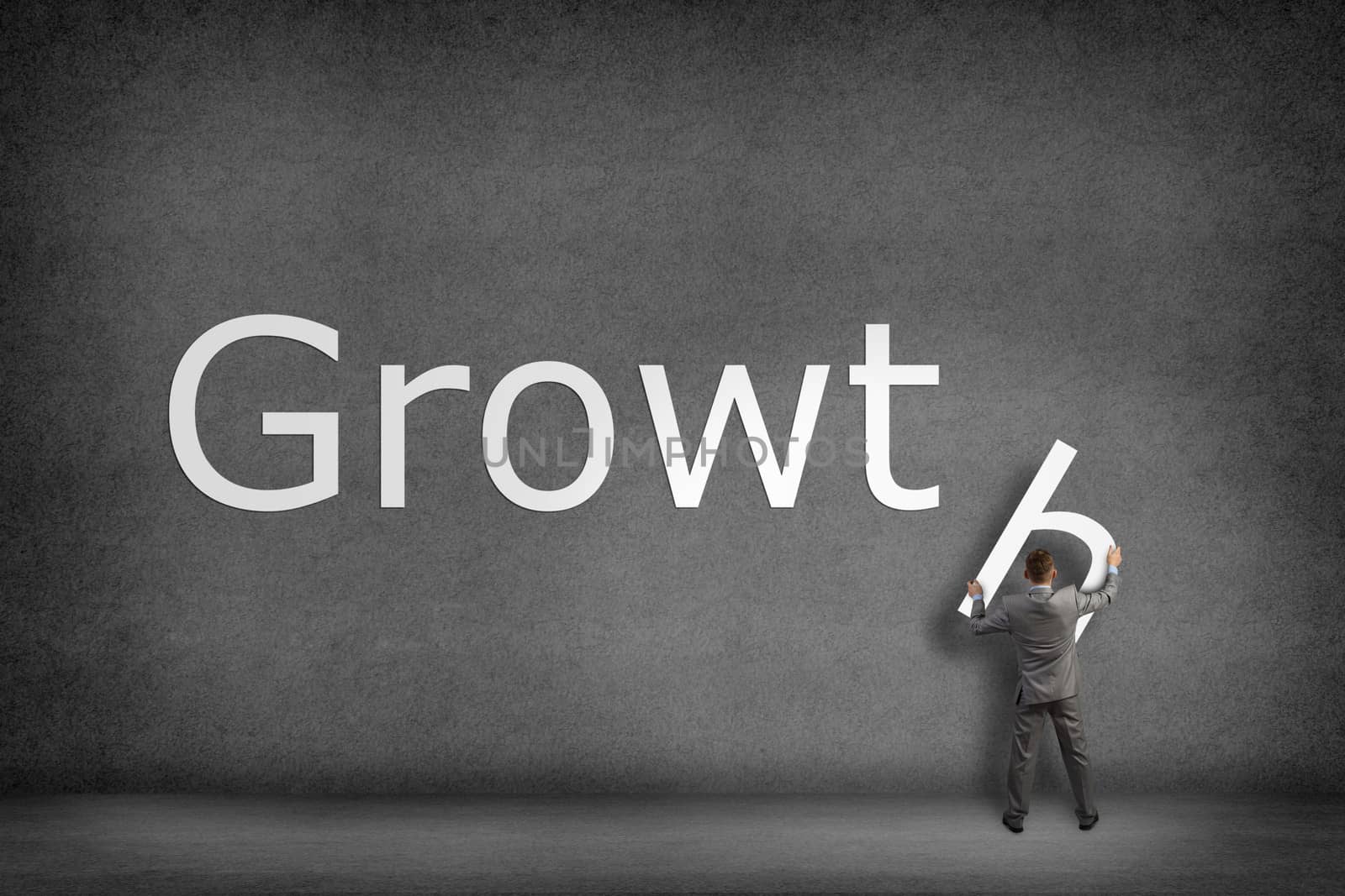 Businessman collects on the wall the word growth by adam121