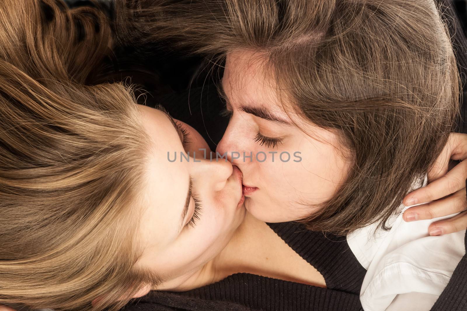 two girlfriends kissing gently portraying lesbians