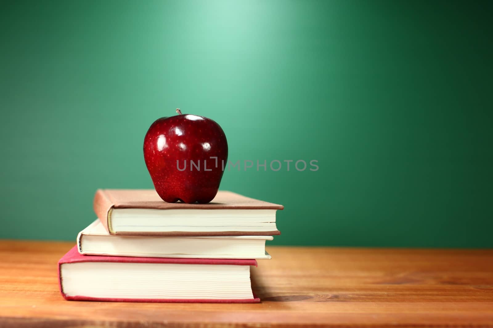 Apple Plus Stack of Books on A Desk for Back to School by tobkatrina