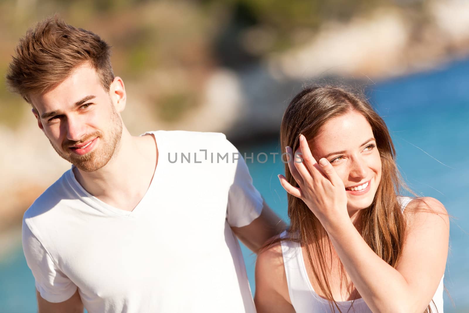 happy young couple on the beach in summer holiday love togetherness