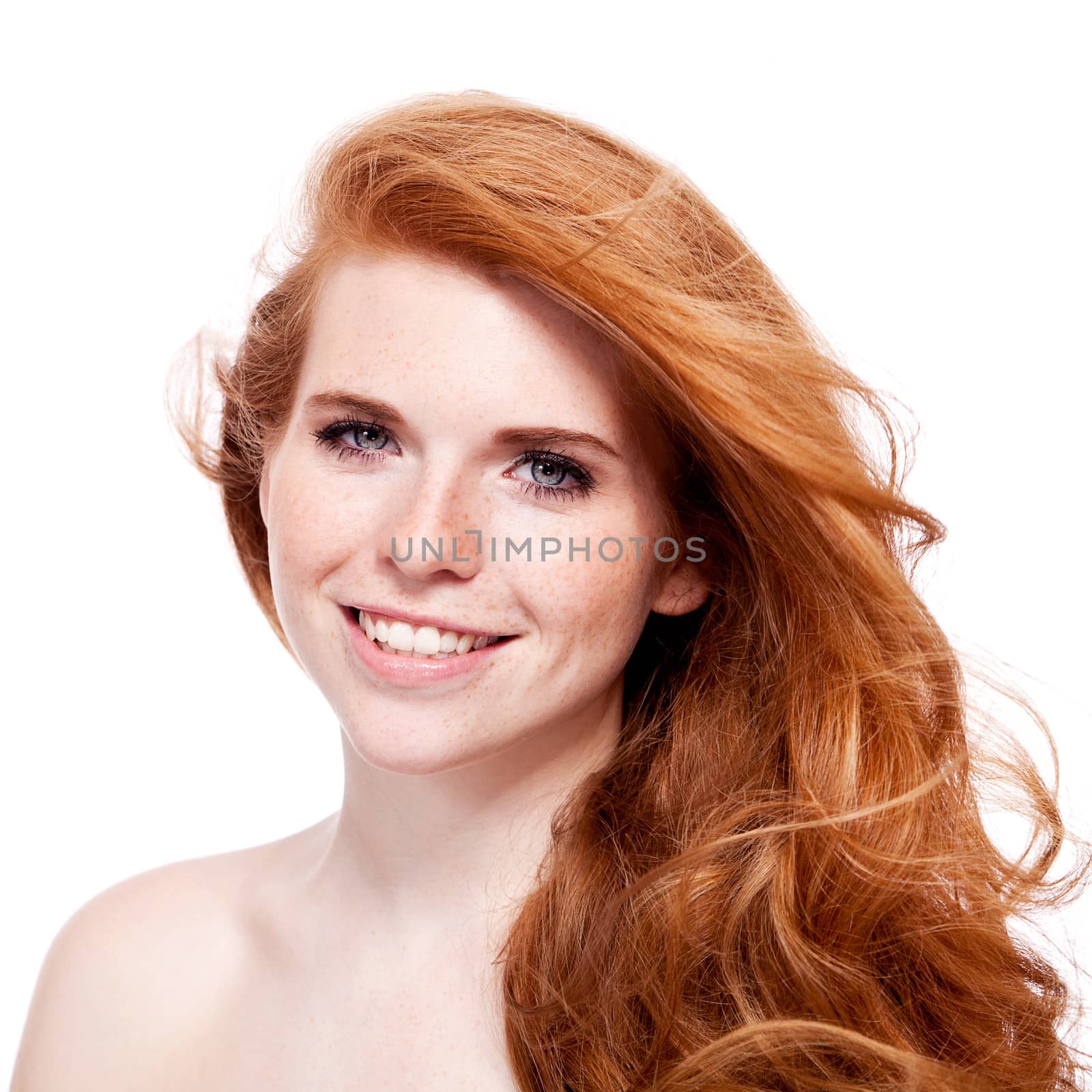 beautiful young redhead woman with freckles portrait isolated on white