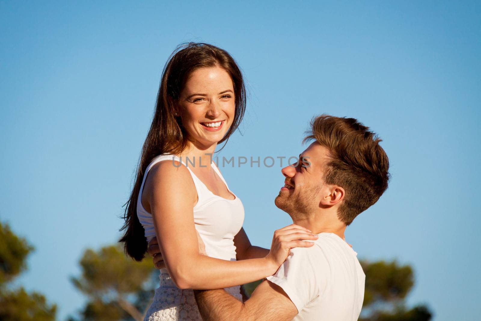 attractive young couple in love summertime on beach smiling romance