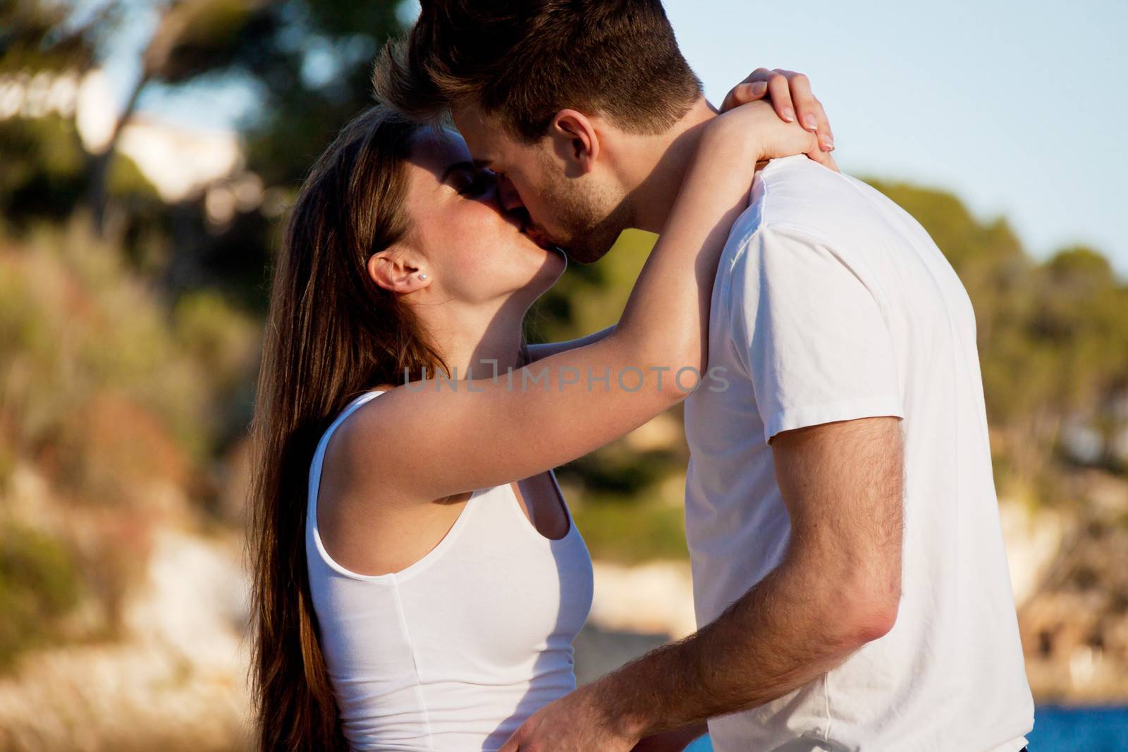 attractive young couple in love summertime on beach smiling romance