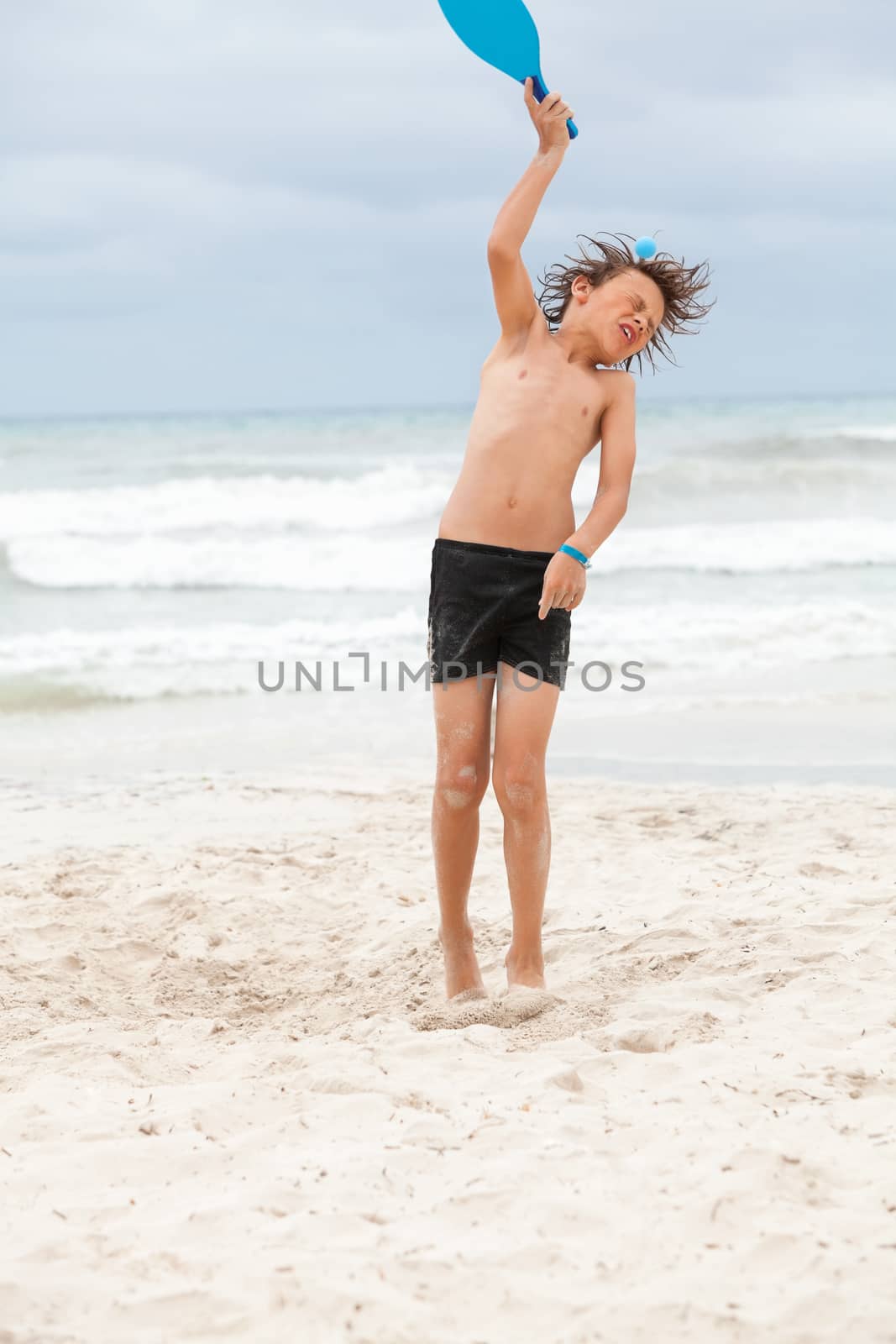happy little child kid boy  playing beachball on beach in summer vacation holiday