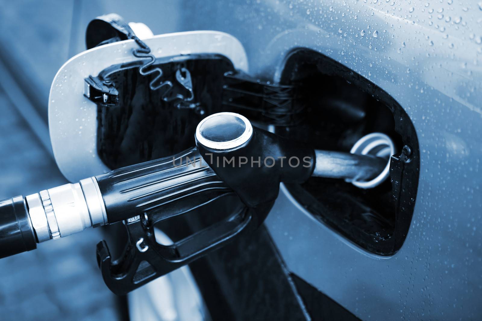 Refuelling of the car by gasoline under a rain