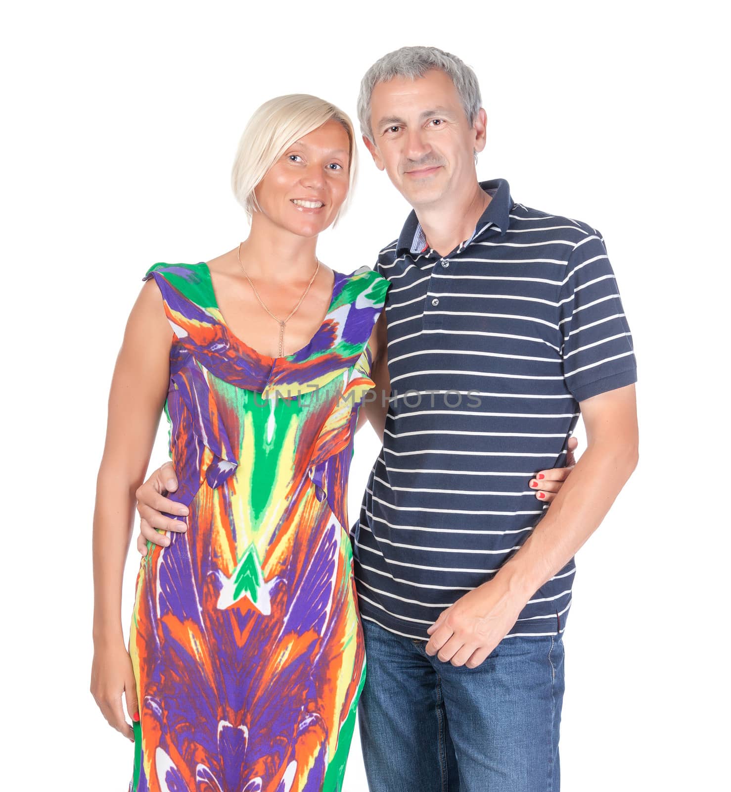 Smiling attractive middle-aged couple standing close together looking at the camera isolated on white