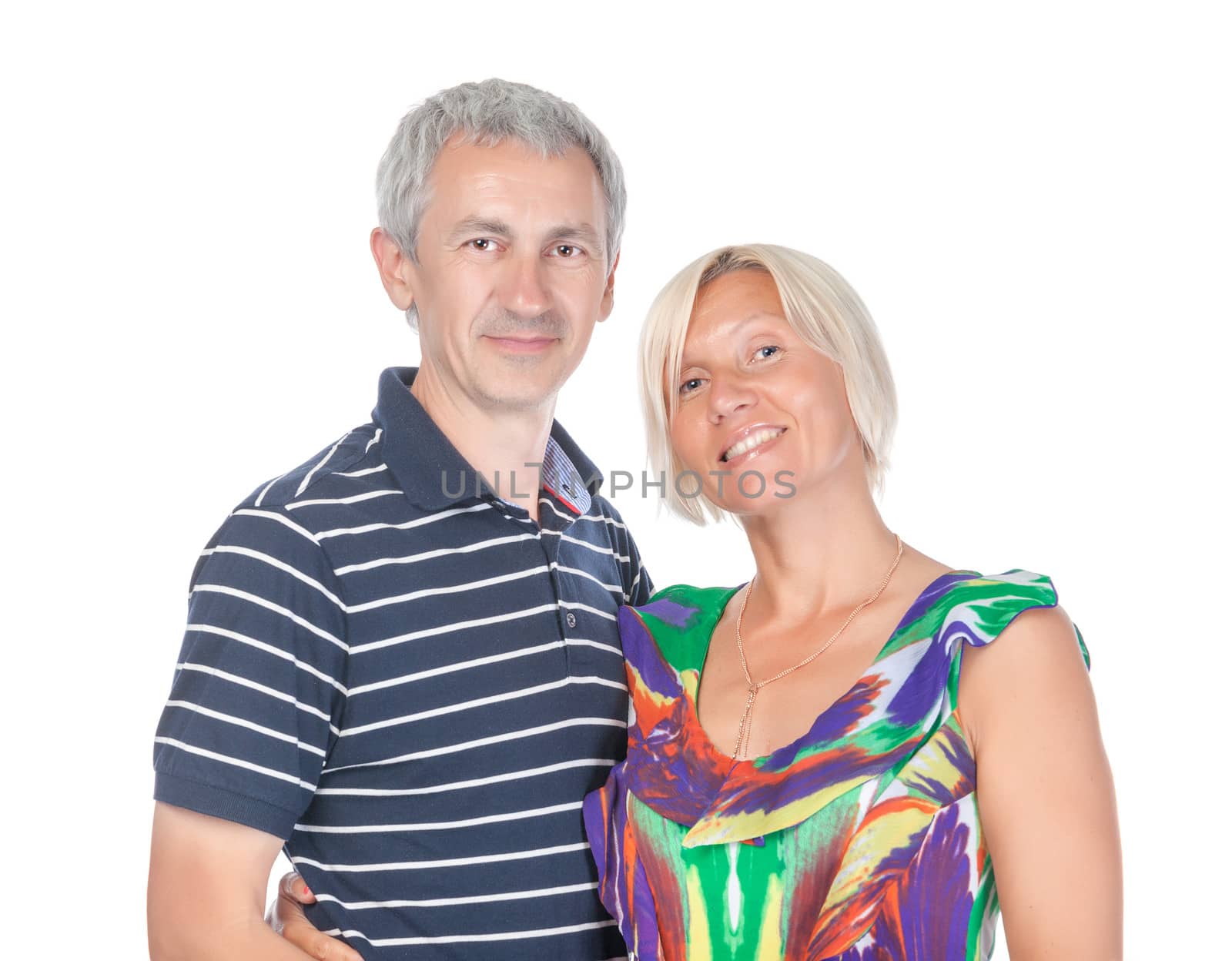 Smiling attractive middle-aged couple standing close together looking at the camera isolated on white