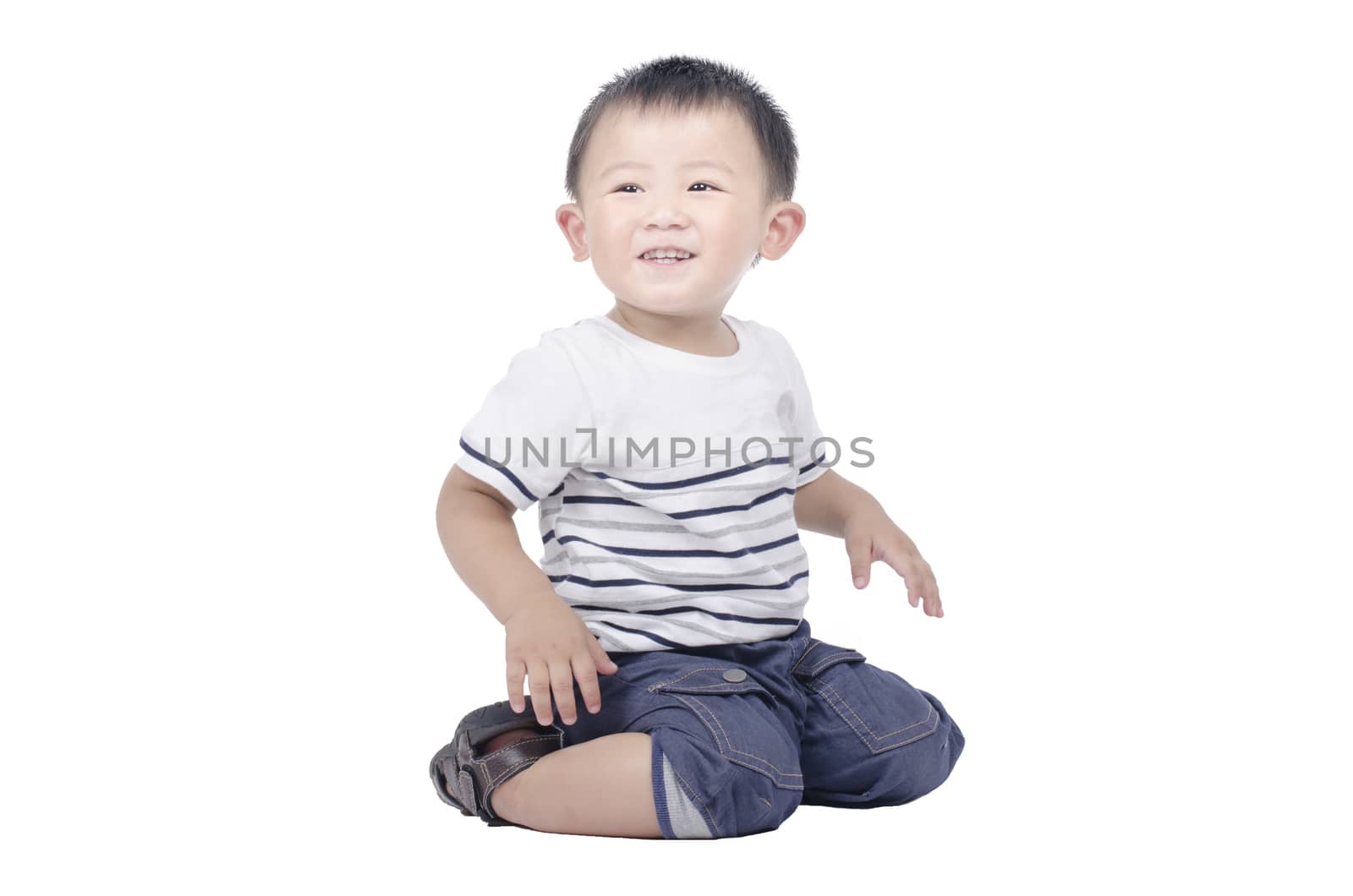 Smiling kid sit on the floor over white background