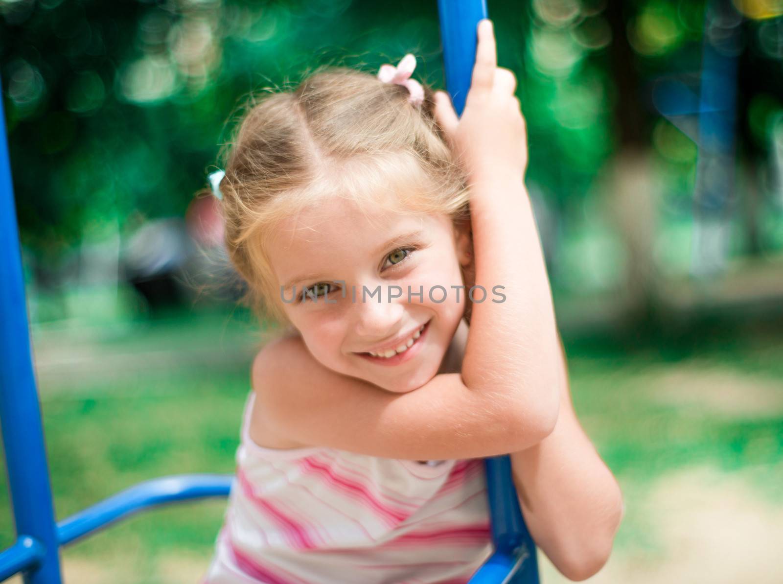 beautiful smiling little girl on a playground