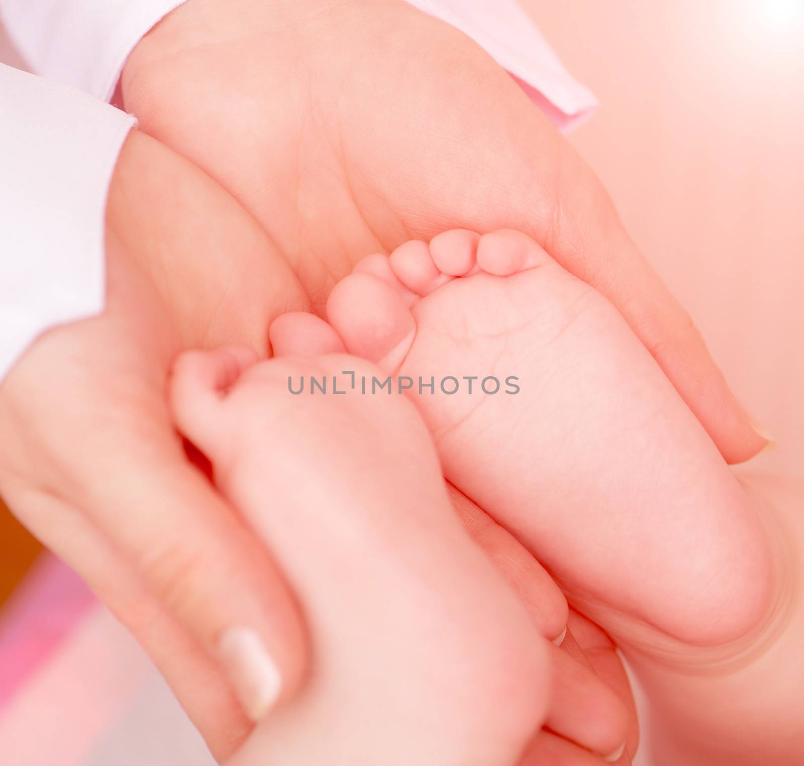 hands massaging little baby's foot