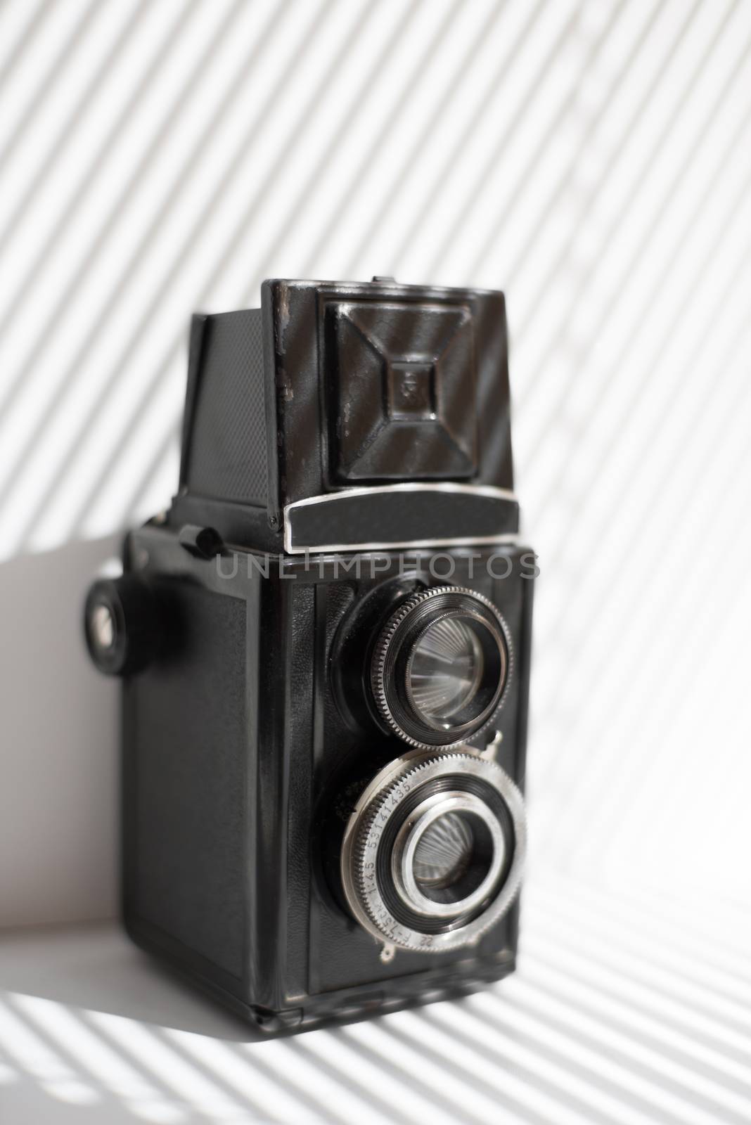 vintage black camera stands on a window sill