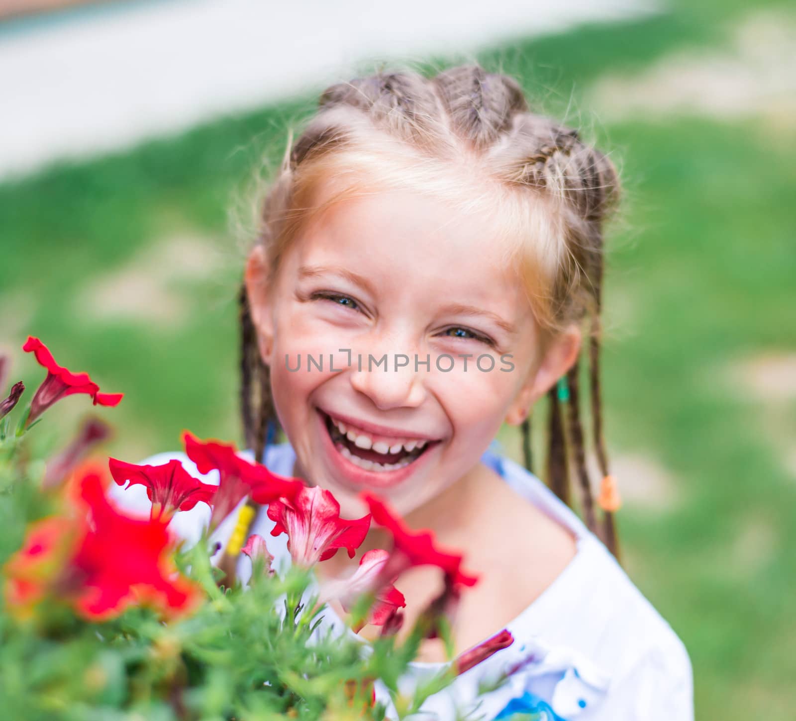 cute little girl in the park with flowers