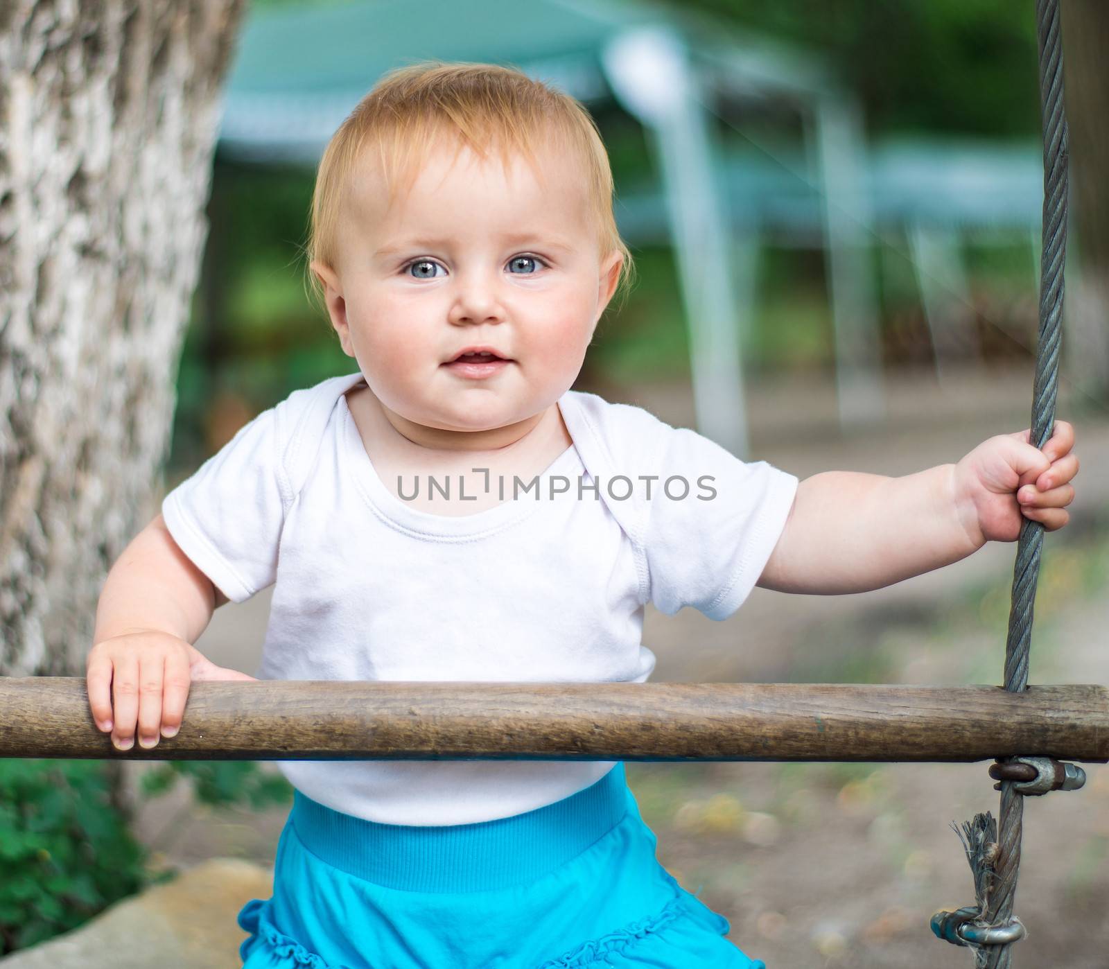 cute beautifil baby looking at camera outdoors