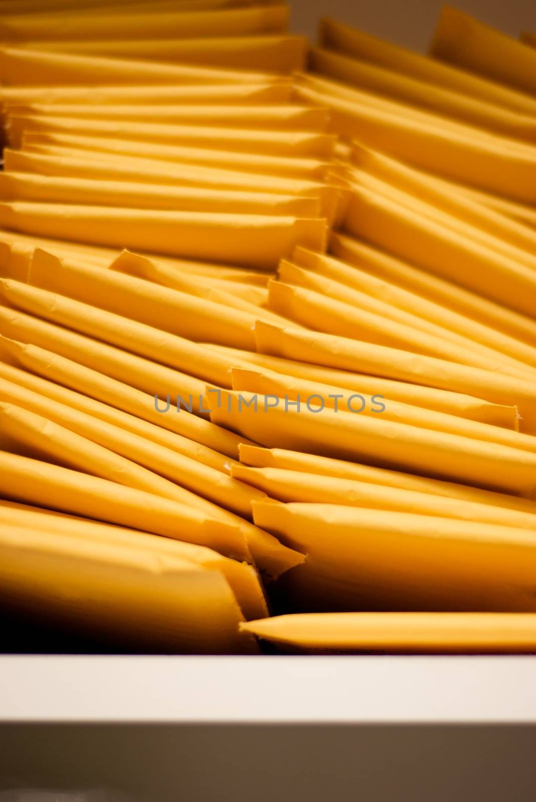 Vertical Pile of Padded Shipping Envelopes by pixelsnap