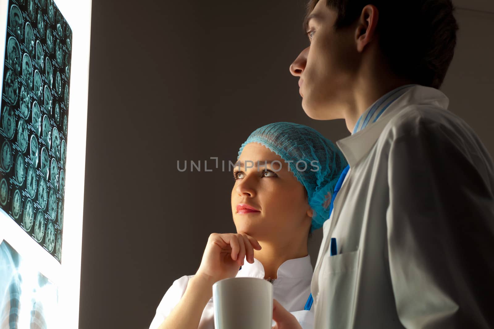 Two doctors examining x-ray results by sergey_nivens