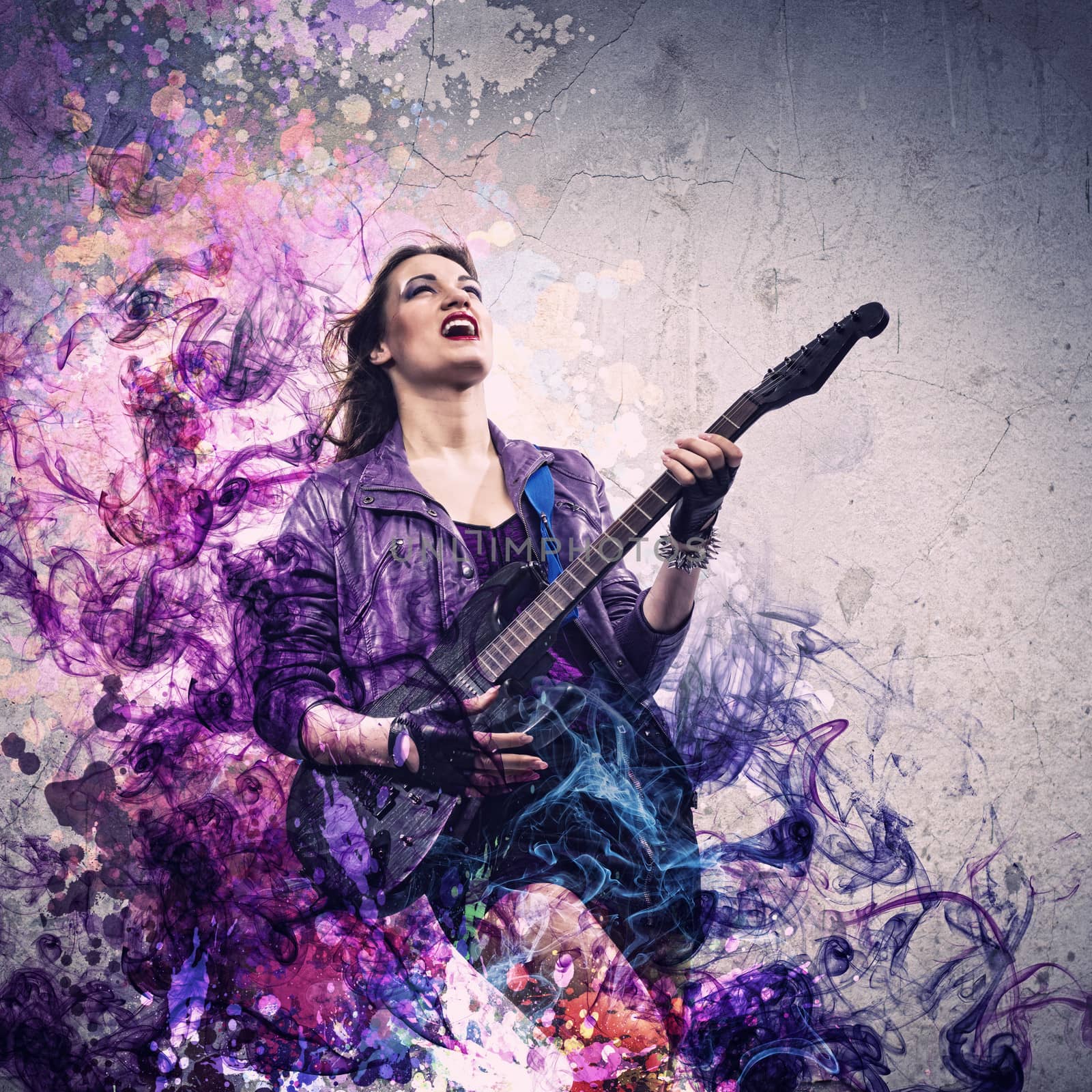 Young attractive rock girl playing the electric guitar