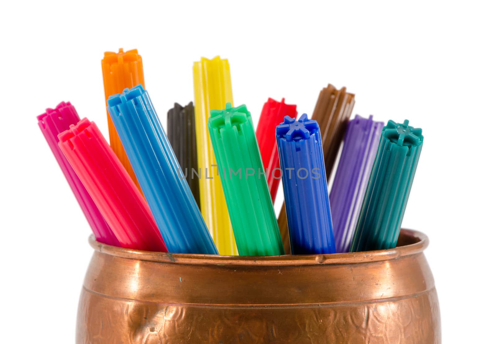 copper box full of colorful felt-tip pens on white by sauletas