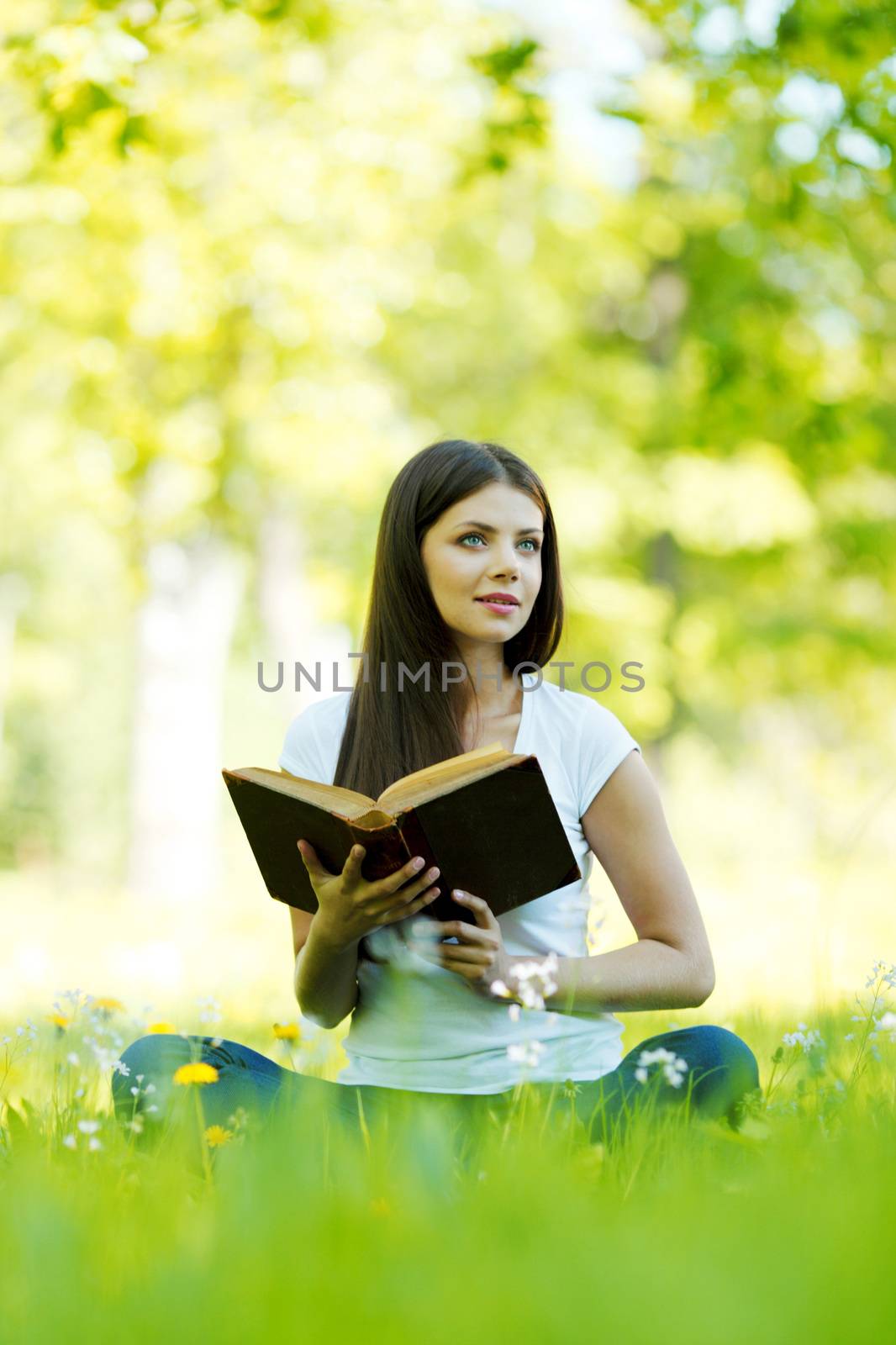 Woman reading book outdoors by Yellowj