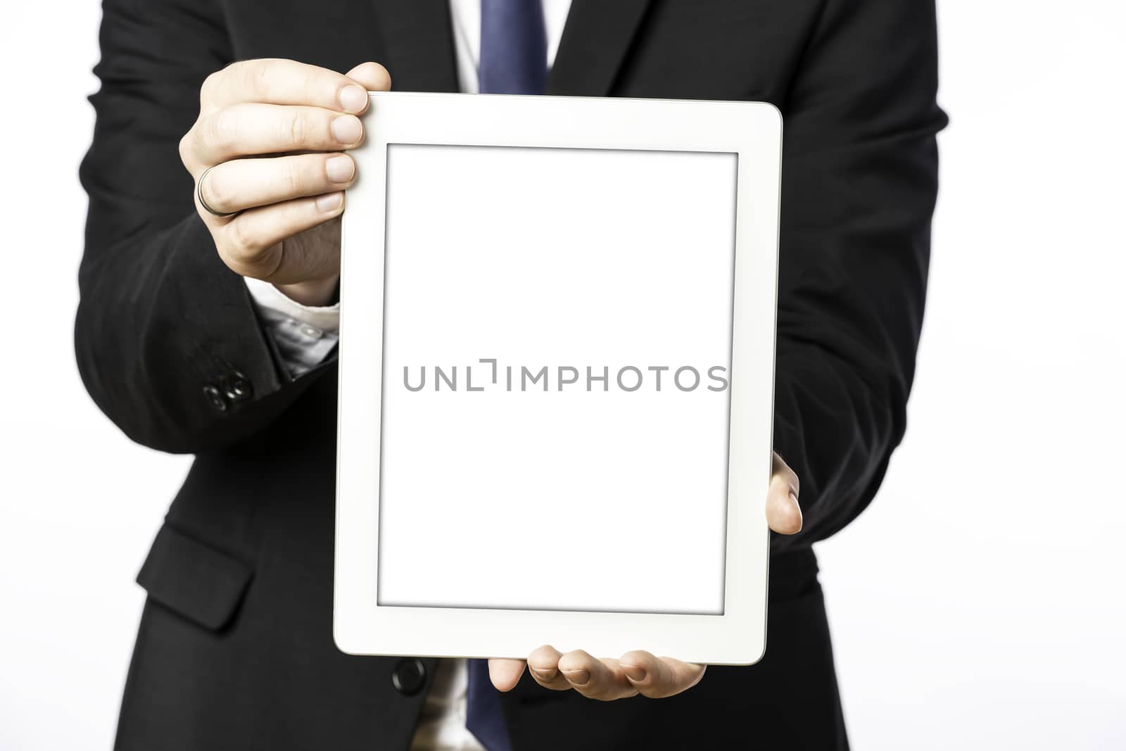 Business man in black suit with shows his blank tablet computer, isolated on white background