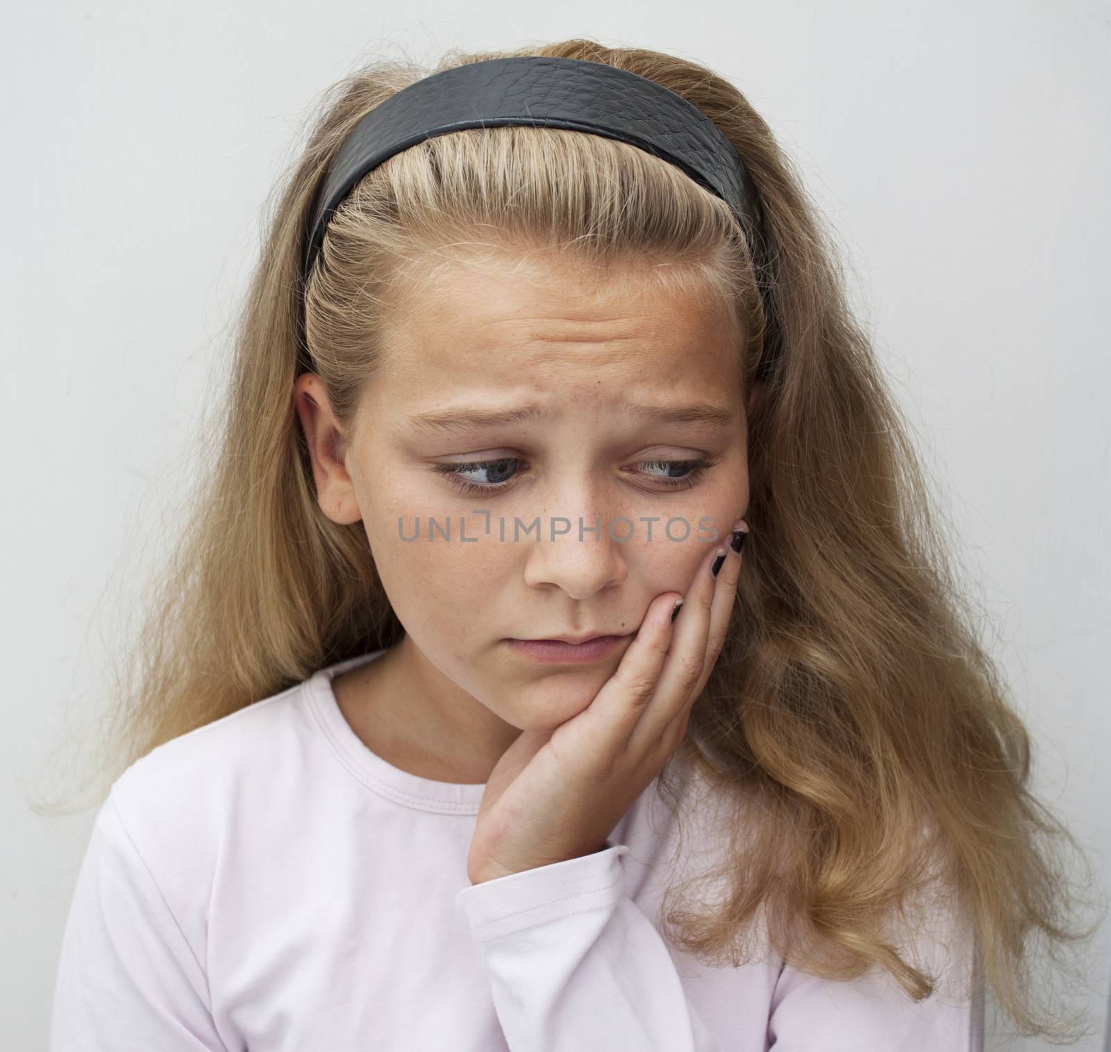 A young teenage girl suffering from tooth ache