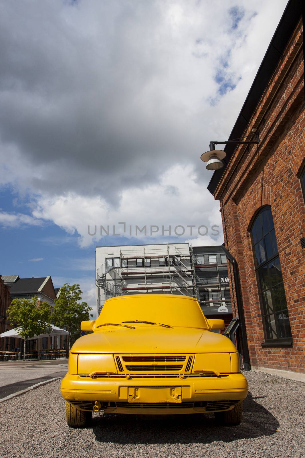 A car painted yellow outside the SAAB museum in Trollhättan, Sweden