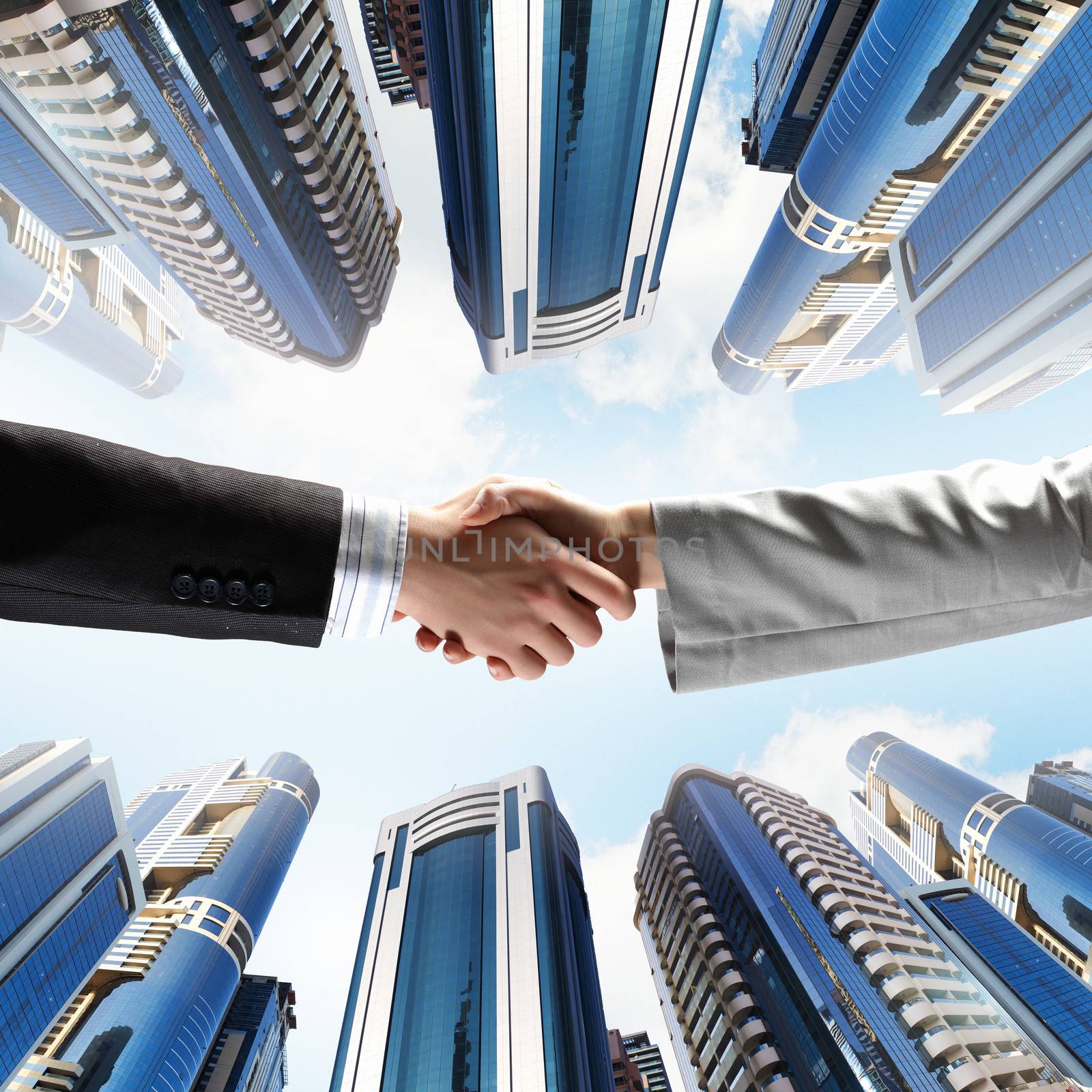 Close up image of hand shake against skyscrapers